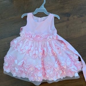 Gorgeous pink dress with rosettes for baby girl